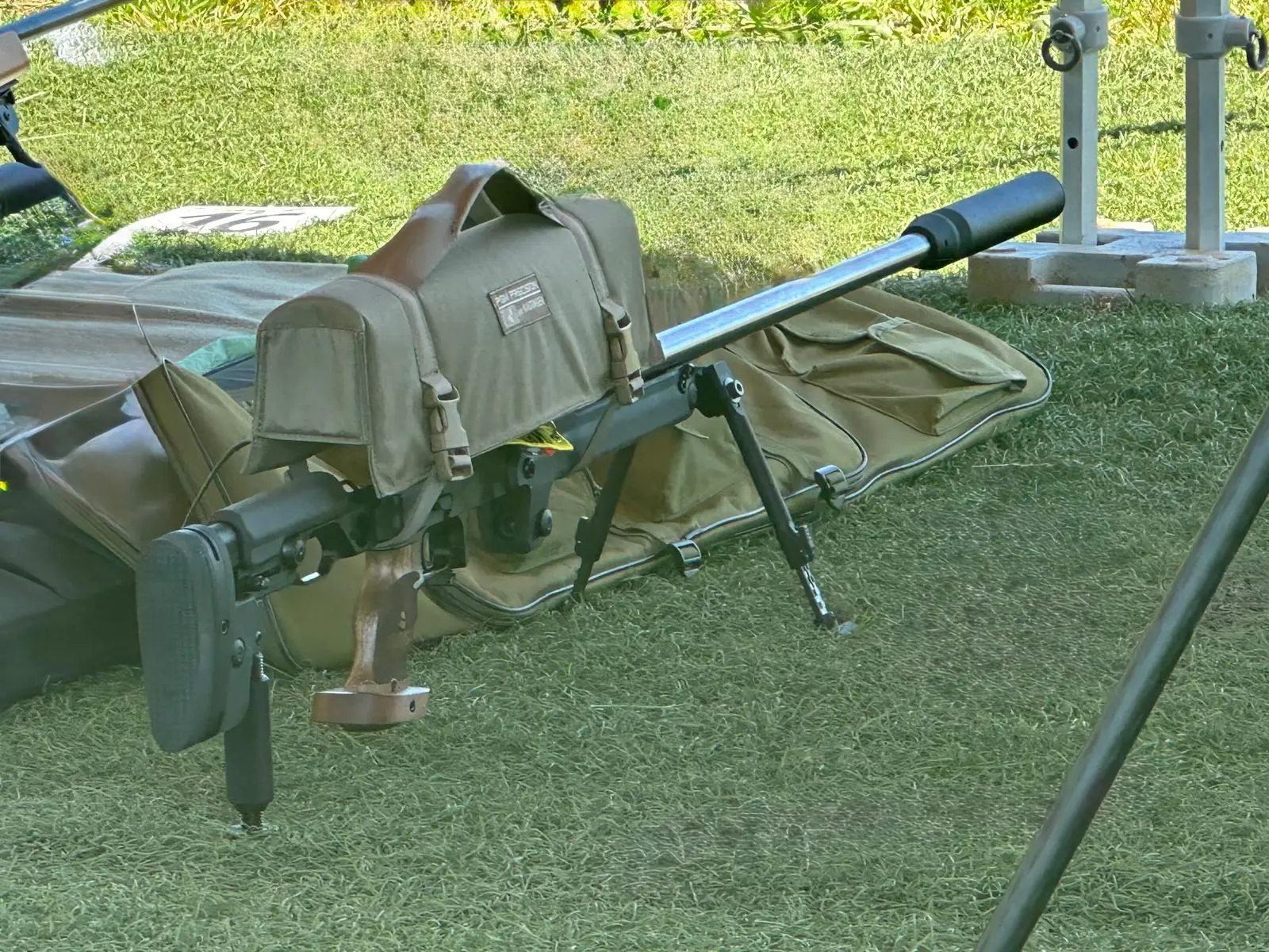 Rifle on a bipod with a rear bag, ready on the shooting mat